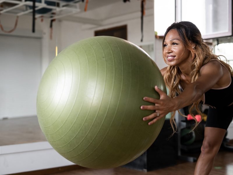 athletic-woman-doing-workout-by-trainer-in-fitness-2023-11-27-05-29-59-utc